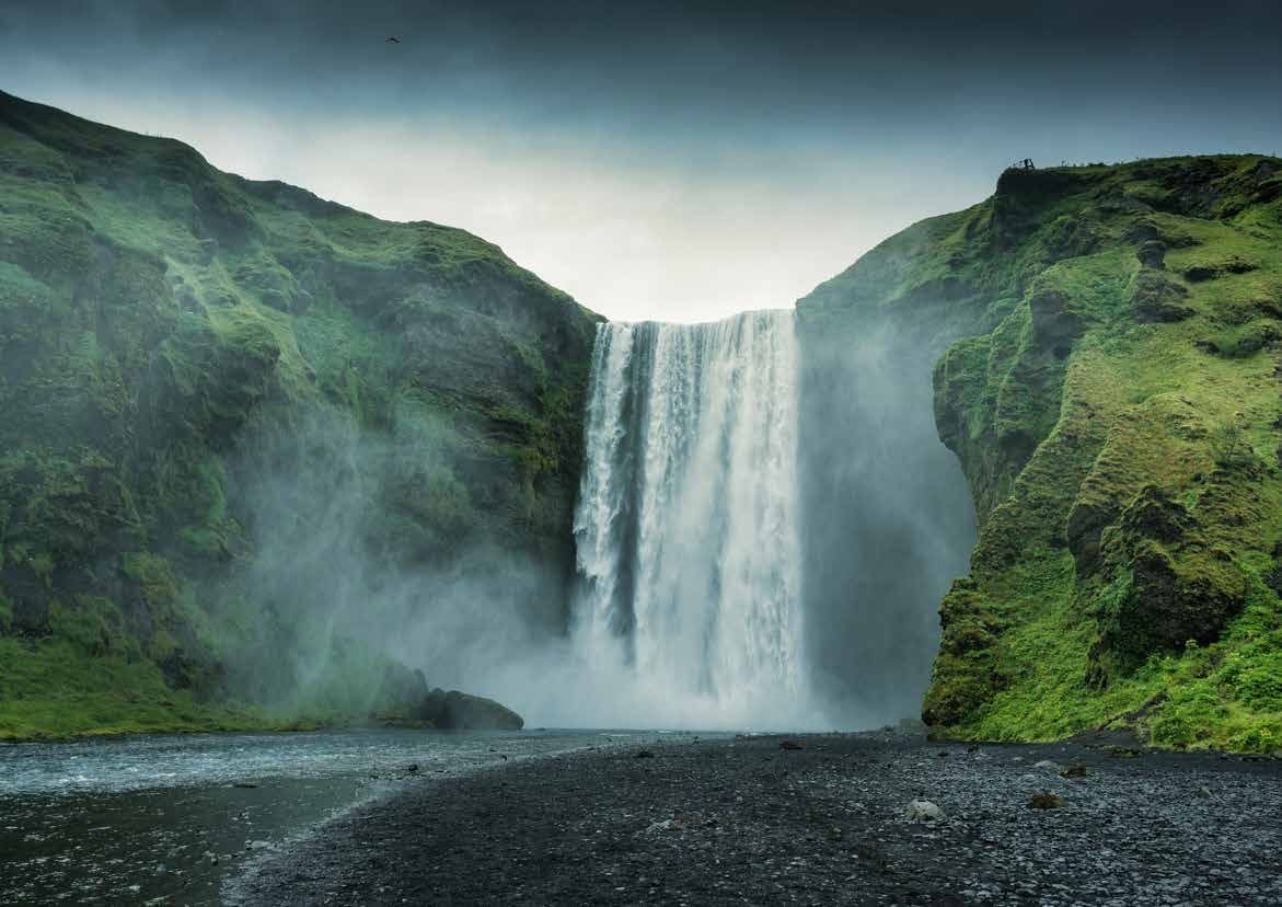 Waterfall and flowing water amid green hills